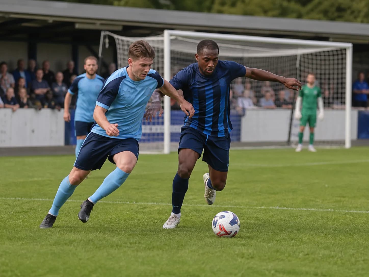 Football players competing for the ball during a club match